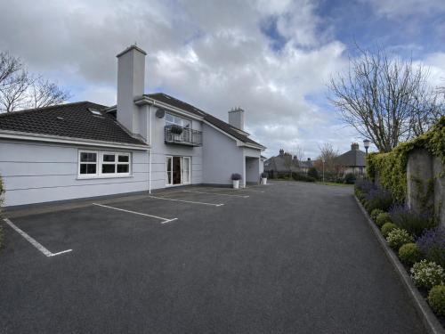 a large white building with a parking lot at Modern and Spacious Apt5 Sleeps 6 Free Parking in Galway