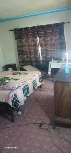 a bedroom with a bed with a blanket on it at James breazy hill in Sandy Bay