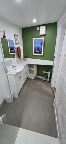 a bathroom with a sink and a toilet and a mirror at furnace halls in Taffs Well