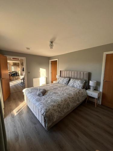 a bedroom with a large bed in a room at Lakeside cottage retreat in Belcoo