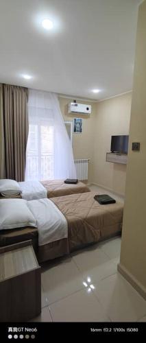 a hotel room with two beds and a window at Motel La Casbah in Constantine