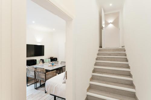 a stairway leading up to a room with a kitchen at Casa Pôr do Sal - Boutique Suites, Sea Views & Heated Pool in Luz