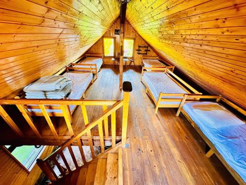a room with four beds in a wooden cabin at Beautiful Rustic Cabin in Prejmer
