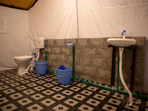 a bathroom with a sink and a toilet at GoingZero Luxury Camps Jispa in Jispa
