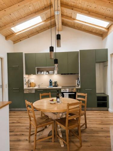 a large kitchen with a wooden table and chairs at Appartment am Angerweg in Warngau