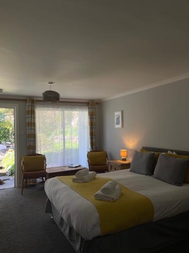 a bedroom with a large bed with two towels on it at The Old Library in Arisaig