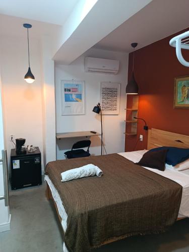 a bedroom with a large bed and a desk at Lapa Bed & Breakfast in Rio de Janeiro