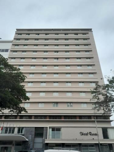 a tall building with a sign on it at San Agustin Riviera in Lima