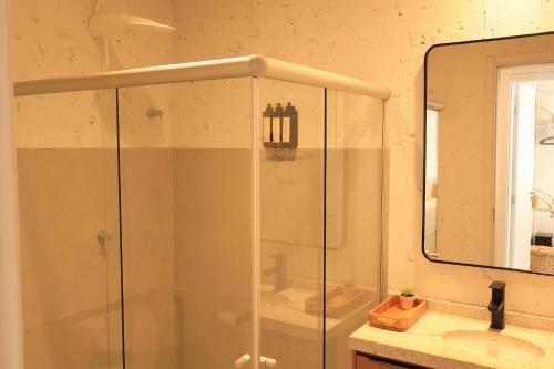 a shower in a bathroom with a sink and a mirror at MHV Milagres - Curimã B 1 in Passo de Camarajibe
