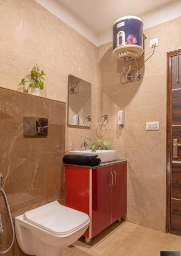 a bathroom with a toilet and a sink at Silver Crest Hotel Kasauli in Kasauli