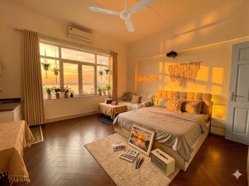 a bedroom with a bed and a table with a laptop on it at CHILLING SUDIO 11 Trinh Cong Son close Ho Tay vs Lotte mail ! in Hanoi