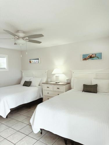 a bedroom with two beds and a ceiling fan at Blackfin Resort and Marina in Marathon