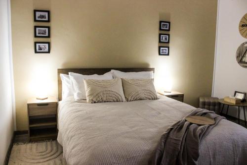 a bedroom with a bed with three pictures on the wall at Soarelui Cozy Studio in Braşov