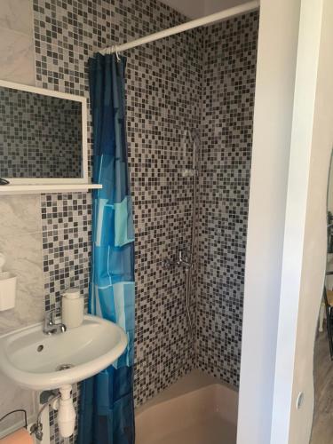 a bathroom with a sink and a shower at Klancic 10 in Novi Vinodolski