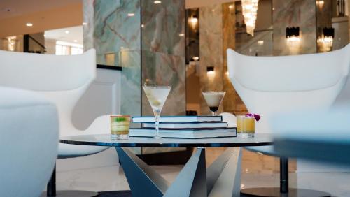 a table with glasses and books on top of it at The Markham Hotel in Gulfport