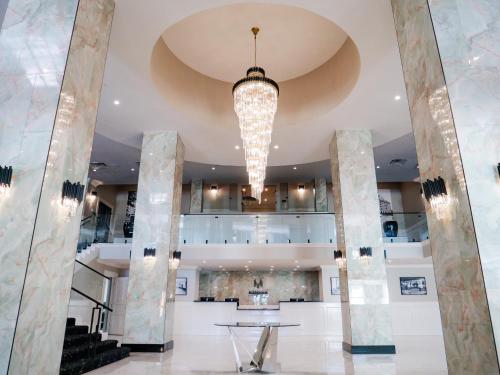 a large lobby with a table and a chandelier at The Markham Hotel in Gulfport