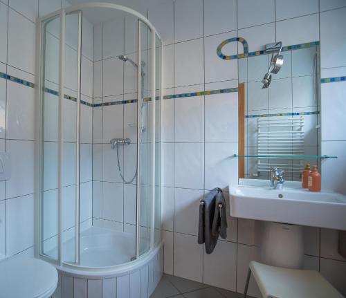 a bathroom with a shower and a toilet and a sink at Gästehaus Eisenerz in Eisenerz