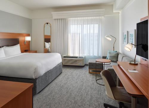 a hotel room with a bed and a desk at TownePlace Suites by Marriott Newnan in Newnan