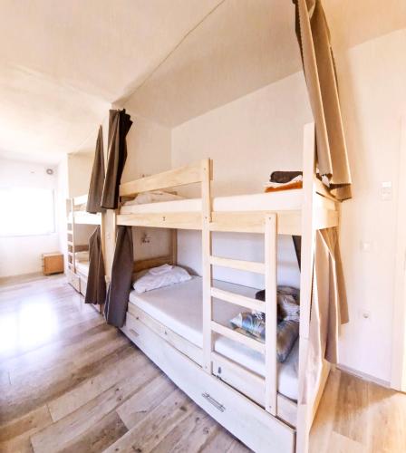 a room with two bunk beds in a room at Backpackers Home in Zadar