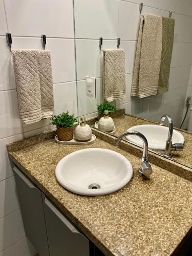a bathroom counter with a sink and two mirrors at APART HOTEL MANAIRA PALACe 2 in João Pessoa