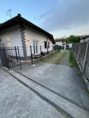 a house with a fence in front of it at El Nido Suite in Tornavento