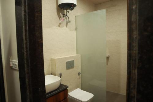 a small bathroom with a sink and a toilet at The Mukhiya Palace in Govardhan