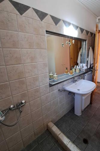 a bathroom with a sink and a mirror at Villa Dimitra in Mourteri