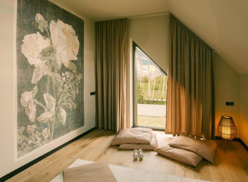 a living room with a large window and two pillows at Wolne Domy in Dominikowice