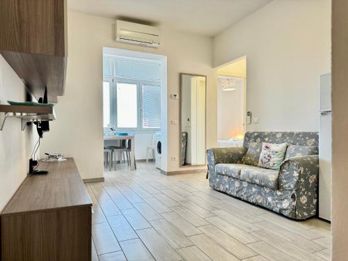 a living room with a couch and a table at 80 Trilocale al Barbara in Lido Adriano