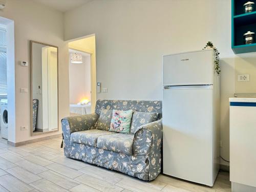 a living room with a couch and a refrigerator at 80 Trilocale al Barbara in Lido Adriano