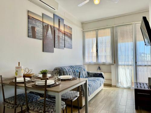 a living room with a table and a couch at Alabastro 40 in Lido Adriano