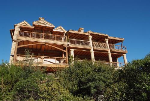 a large wooden house on top of a hill at Secret Arcadia Bay - Maisonette Breathtaking sea & mountain view-Just on the beach in Áyios Andréas Arkadias