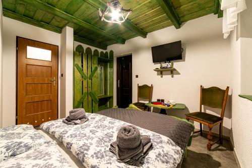 a bedroom with a bed with towels on it at Agroturystyka Gościniec Ethoria in Łomnica