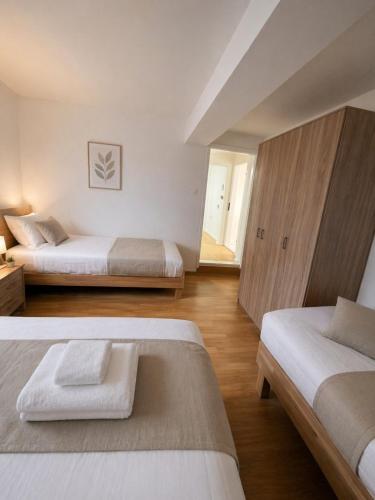 a bedroom with two beds and a wooden cabinet at Sasha Apartment and Swimming Pool in Gornje Selo