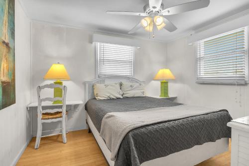 a bedroom with a bed and a ceiling fan at Sunkissed 2 by Oak Island Accommodations in Oak Island