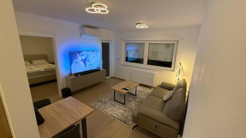 a living room with a couch and a table at Level Apartment in Kostajnica