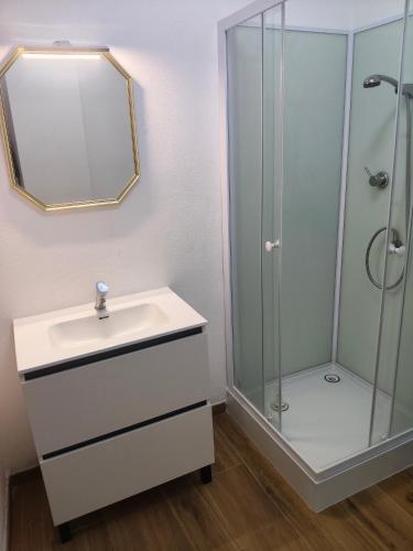 a bathroom with a sink and a shower at La posada del Mozarabe in Alquife