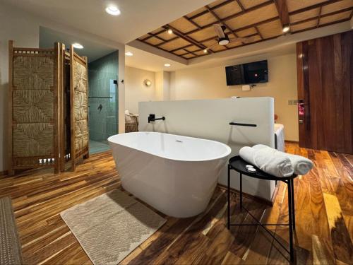 a bathroom with a large white tub and a shower at Musa Hotel Boutique in Bucerías