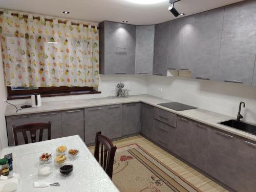 a kitchen with a table and a sink at Sayora Guest House in Khorugh