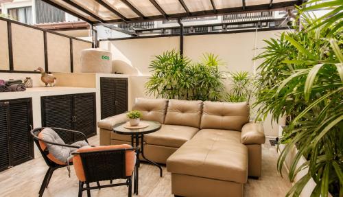 a living room with a couch and some plants at 3br Townhouse Laguna Park in Layan Beach