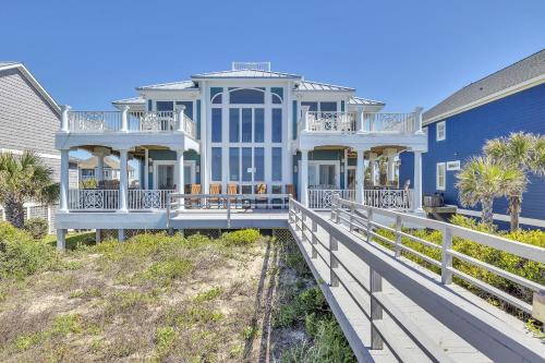 a large house on the beach with a porch at Surviving Stress by Oak Island Accommodations in Caswell Beach