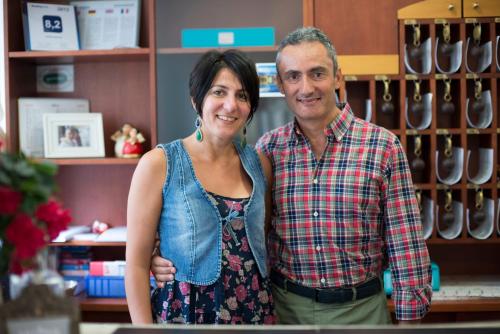 a man and a woman standing in a store at Hotel Astoria in Ravenna