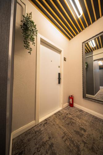 a hallway with a white door and a mirror at Complex Rediu 54 Luxury Apartaments in Iaşi