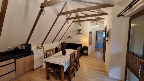 a kitchen and dining room with a table and chairs at Domek Julia in Krościenko