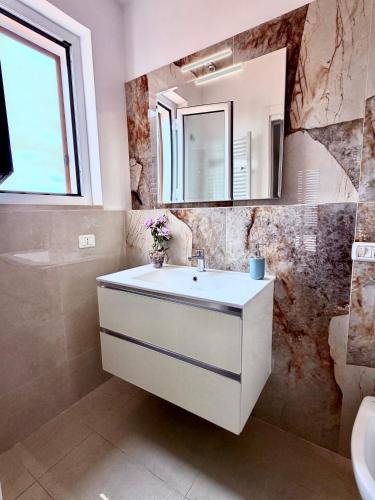 a bathroom with a sink and a mirror at D ANNUNZIO house in Martinsicuro