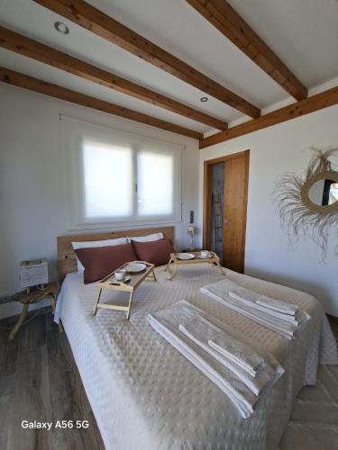 a bedroom with a large bed and a window at Meco Beach House in Sesimbra