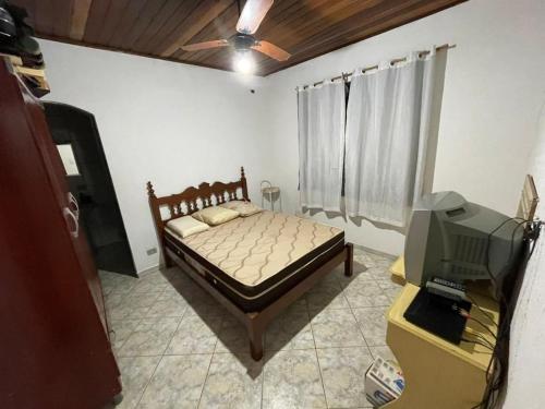 a bedroom with a bed and a television in it at Farm km 68 Castelo Branco in Mairinque