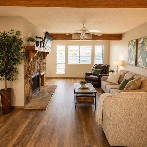 a living room with a couch and a fireplace at The Calm Cove - Near shopping and entertainment in Osage Beach