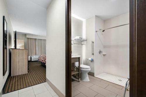 a bathroom with a toilet and a shower at Red Roof Inn & Suites Tomah in Tomah