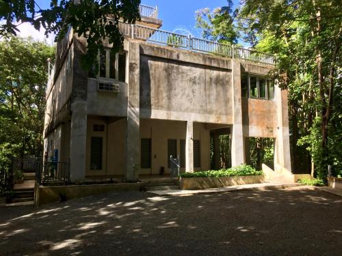 an old building with trees in front of it at Dos Aguas in Rio Grande